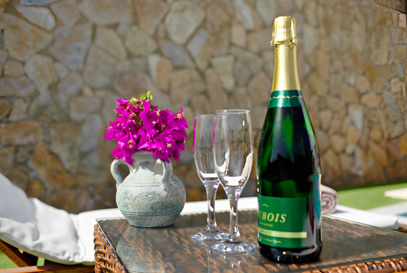 Bougainvillea and champagne by the stone wall